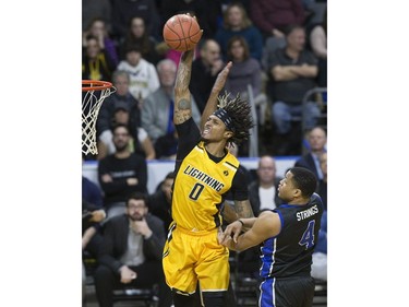 Mo Bolden of the London Lightning soars past Justin Strings of the Kitchener Waterloo Titans  to slam home two points during their game in London on Sunday Feb. 17, 2019. Derek Ruttan/The London Free Press