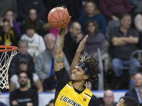 Mo Bolden of the London Lightning soars past Justin Strings of the Kitchener Waterloo Titans  to slam home two points during their game in London on Sunday Feb. 17, 2019. Derek Ruttan/The London Free Press