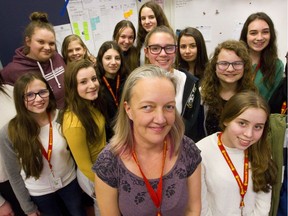 Saunders secondary school math teacher Sylvie Gaede poses with 15 of the 20 female Grade 9 students who enrolled in the STEM program at the school. Despite efforts by people such as Gaede, women are outnumbered in some science, technology, engineering and math programs in post secondary institutions in Ontario. (Mike Hensen/The London Free Press)
