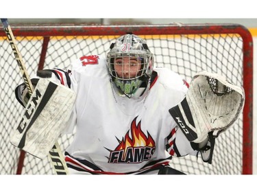 STA's  goalie Mike deHenestrossa watches a puck sail high over his blocker over the net during their semi-final game against the Bessette Bulldogs Thursday at Carling arena. The Flames roared to a 6-2 win, forcing a game 3 Friday at Boswick arena. The Bulldogs won the first 4-1. Mike Hensen/The London Free Press/Postmedia Network