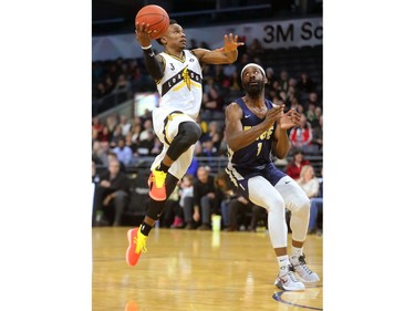 Alex Johnson of the London Lightning gets in on Obinna Oleka of the St John's Edge during their NBL game at Budweiser Gardens on Thursday, Feb. 21, 2019.  Mike Hensen/The London Free Press