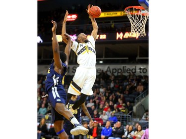 Marcus Capers of the London Lightning is fouled by Olu Ashaolu of the St John's Edge during their NBL game at Budweiser Gardens on Thursday, Feb. 21, 2019.  Mike Hensen/The London Free Press