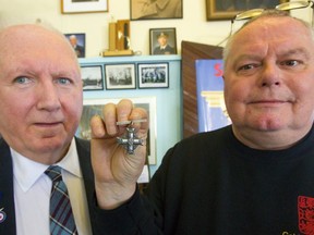 Rene McKinnon of the 427 Wing London and Dave Thomson hold the Silver Cross awarded to the mom of George Graham Hall, who died in training for the Second World War. The medal was given to the wing by Dave Thomson, who found it on EBay and then collected funds to purchase it. Thomson has purchased more than 1,000 medals of Canadian soldiers, seaman and aviators for Canadian museums or families. Mike Hensen/The London Free Press