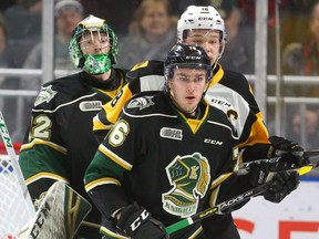 Joseph Raaymakers looks way up to see over Hamilton's captain Matthew Strome and Billy Moskal of the London Knights in the first period of their game at Budweiser Gardens on Friday  (Mike Hensen/The London Free Press)