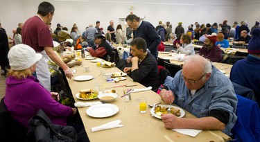 People line up for a warm meal Sunday at the Jewish Community Centre. For the 13th year straight the organization has been hosting a Come out of the Cold meal for anyone in London who needs a warm meal. About 300 people were served in the centre, most arriving by buses organized to pick up groups in downtown and east London.  Mike Hensen/The London Free Press