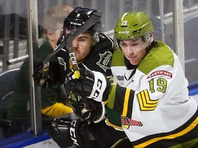 Mason Primeau of the North Bay Battalion forechecks Knights defenceman Riley Coome behind the Knight net on Sunday. Mike Hensen/The London Free Press