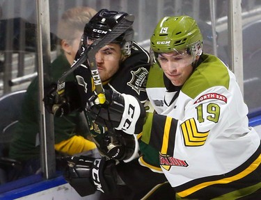 Mason Primeau of the North Bay Battalion forechecks Knights defenceman Riley Coome behind the Knight net on Sunday February 24, 2019.  The Knights finally got their offence running with 8 goals so far in the game. Mike Hensen/The London Free Press/Postmedia Network