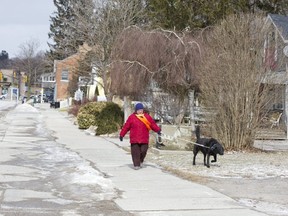 Lynn Rawlings takes her black lab "Hemi" for a walk in Port Stanley, Ont. on Monday. "I hate winter," she laughed. "But he drives me crazy if I don't take him for a walk." Derek Ruttan/The London Free Press