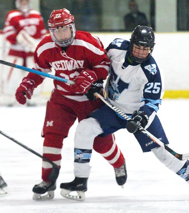 Medway Cowboy Kane Johnson and Lucas Viking Riley Kiriakakos vie for possession of the puck during their TVRA AAA Central game at Nichols Arena  in London, Ont. on Tuesday. The Cowboys won the game 6-1 to take the championship series two games to none. Derek Ruttan/The London Free Press/Postmedia Network