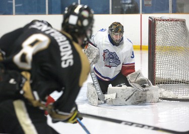 Saint Andre Bessette Bulldog goalie Gordie O'Dwyer catches a shot by  Holy Cross Centurion Bradley Slegers at Nichols Arena  in London. The Bulldogs won the game 4-2 and the TVRA AA London District championship series two games to none. Derek Ruttan/The London Free Press/Postmedia Network