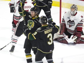 London Knight Kevin Hancock and Adam Boqvist celebrate in front  Guelph Storm goalie Anthony Popovich after Hancock swung his stick like a baseball bat and swatted the puck out of the air and into the net during the first period of their game in London, Ont. on Tuesday. Derek Ruttan/The London Free Press/Postmedia Network