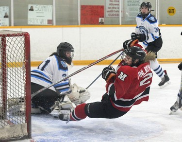 Hannah Finlayson of the Medway Cowboys wipes out after dekeing and scoring on Lucas Vikings goalie Maddie Casson during their playoff game at Carling Arena in London, Ont. on Wednesday. Medway won the game 6-1 to take the series 2-0 and win the TVRA Central hockey championship. Derek Ruttan/The London Free Press/Postmedia Network