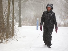 Jen Hodge of London is well dressed for her daily walk along the multi-use pathways along the river in London, Ont.   Mike Hensen/The London Free Press/Postmedia Network