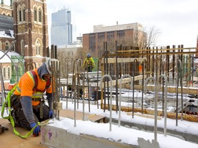 Mike Oliveira of EllisDon measures the concrete forms for what eventually will be part of a staircase in the Old Oak Properties tower being built on 515 Richmond Street at Dufferin Avenue.  Mike Hensen/The London Free Press