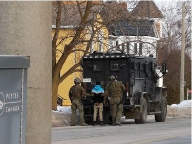 Police officers escort a handcuffed suspect to vehicle after a nearly nine-hour standoff on Main Street in Listowel.
(Crystal Kaiser/Special to the Beacon Herald)