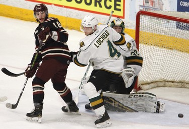 Peterborough Petes' Adam Timleck, left, is checked off a rebound by London Knights' William Lochead next to goalie Joseph Raaymakers during first period OHL action on Thursday, Feb. 21, 2019 at the Memorial Centre in Peterborough. (Clifford Skarstedt, Peterborough Examiner)