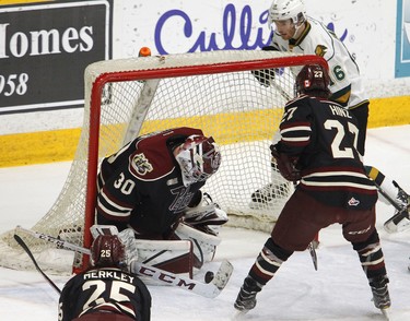 Peterborough Petes' goalie Tye Austin pounces on a rebound shot by London Knights' Kevin Hancock during first period OHL action on Thursday, Feb. 21, 2019 at the Memorial Centre in Peterborough. (Clifford Skarstedt, Peterborough Examiner)