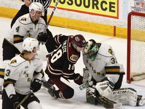 Peterborough Petes' Adam Timleck (16) is checked into London Knights' goalie Joseph Raaymakers by William Lochead during first period OHL action on Thursday, Feb. 21, 2019 at the Memorial Centre in Peterborough. (Clifford Skarstedt, Peterborough Examiner)