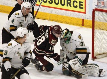 Peterborough Petes' Adam Timleck (16) is checked into London Knights' goalie Joseph Raaymakers by William Lochead during first period OHL action on Thursday, Feb. 21, 2019 at the Memorial Centre in Peterborough. (Clifford Skarstedt, Peterborough Examiner)