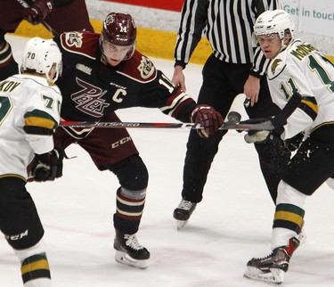 Peterborough Petes' Zach Gallant, left, battles for the puck against London Knights' Connor McMichael during first period OHL action on Thursday, Feb. 21, 2019 at the Memorial Centre in Peterborough. (Clifford Skarstedt, Peterborough Examiner)
