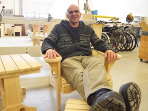 David Vine sits on a lawn chair built in his woodworking class at Strathroy Disctrict Collegiate Institute. This year he'll teach elementary school kids how to craft the same chair, and other deck furniture, as part of a municipally-funded program to get students interested in skilled trades. (Louis Pin/Sarnia Observer)
