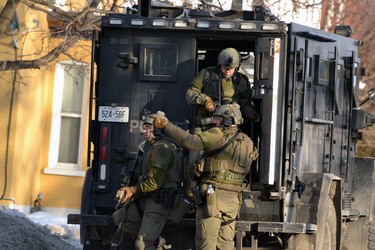 Armed tactical officers were part of the "containment" of a Main Street home in Listowel on Friday. Police had surrounded the house as part of an ongoing investigation of a wanted person. GALEN SIMMONS/STAFF REPORTER
