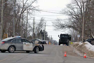 As part of their containment efforts Friday, Perth County OPP officers blocked off a section of Main Street in Listowel between Victoria and Barber avenues. Police were at the scene as part of an ongoing investigation of a wanter person. GALEN SIMMONS/BEACON HERALD