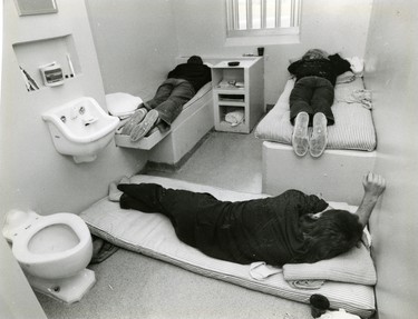 Three inmates at Elgin-Middlesex Detention Centre demonstrate the sleeping arrangement in a cell meant for two, 1988. (London Free Press files)