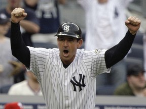 FILE - In this May 23, 2009, file photo, New York Yankees third base coach Rob Thompson celebrates as the Yankees score against the Philadelphia Phillies during the ninth inning of a baseball game in New York.