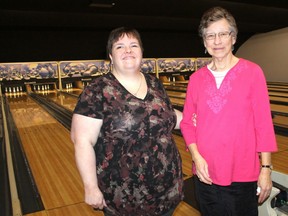 Michelle Gibbs and volunteer Jane K. prepare to knock down some pins during Sarnia-Lambton White Cane's weekly bowling social at Point Edward's Mancin Bowl.  (Carl Hnatyshyn/Postmedia Network)