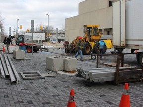 Crews work on Monday setting up a large media tent on Dundas Place, behind the Budweiser Gardens. The tent will be used during the Juno Awards ceremony at the Bud on Sunday. Work on the stretch of Dundas Street between Ridout and Talbot streets is expected to completed by Wednesday, though the area will remain closed to traffic while Juno Week activities take place in the area this week.