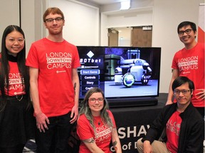 Fanshawe students Christina Nguyen, Brandon Turner, Skye Vidler, Alex Wong, Anthony Seeha, creators of the video game BOTbot, showed off the game at a music and video game conference in London on Thursday, March 14, 2019. (MEGAN STACEY/The London Free Press)
