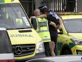 Police and ambulance staff help a wounded man from outside a mosque in central Christchurch, New Zealand, Friday, March 15, 2019. A total of 49 Muslim worshipers were shot and killed in and around two mosques. (AP Photo/Mark Baker)