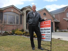 Earl Taylor, president of the London-St. Thomas Association of Realtors, stands outside a home for sale in St. Thomas. (JONATHAN JUHA, The London Free Press)