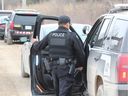 Oneida police Const. Eddie King was one of more than a dozen officers stationed at River Road Wednesday as part of an investigation into a smash-and-grab robbery at a London jewelry store the previous day. Four men are charged in the robbery. (DALE CARRUTHERS/The London Free Press)
