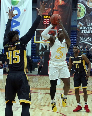 Braylon Rayson of the Sudbury Five goes up for a shot while Marvin Phillips and Jaylen Babb-Harrison of the London Lightning defend during first-half National Basketball League of Canada action at Sudbury Community Arena in Sudbury on Sunday. (Ben Leeson/Postmedia Network)