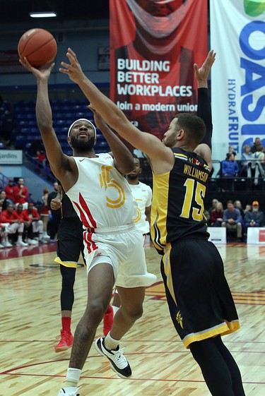 Dexter Williams Jr. of the Sudbury Five drives to the hoop for a shot while Garrett Williamson of the London Lightning defends during first-half National Basketball League of Canada action at Sudbury Community Arena in Sudbury on Sunday. (Ben Leeson/Postmedia Network)