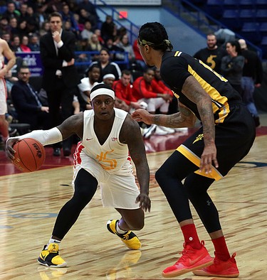 Braylon Rayson of the Sudbury Five handles the ball while Mo Bolden of the London Lightning defends during first-half National Basketball League of Canada action at Sudbury Community Arena in Sudbury on Sunday.