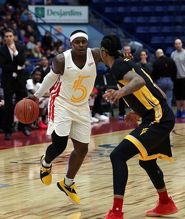 Braylon Rayson of the Sudbury Five handles the ball while Mo Bolden of the London Lightning defends during first-half National Basketball League of Canada action at Sudbury Community Arena in Sudbury on Sunday.  (Ben Leeson/Postmedia Network)