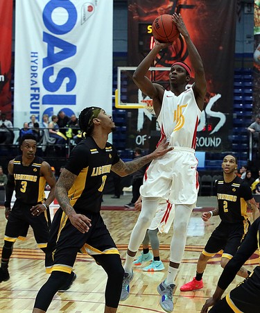 Mamadou Gueye of the Sudbury Five takes a jump shot while Mo Bolden of the London Lightning defends during first-half National Basketball League of Canada action at Sudbury Community Arena in Sudbury on Sunday.  (Ben Leeson/Postmedia Network)