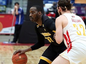 Kirk Williams Jr. of the London Lightning handles the ball while Devin Gilligan of the Sudbury Five defends during first-half National Basketball League of Canada action at Sudbury Community Arena in Sudbury on Sunday. (Ben Leeson/Postmedia Network)