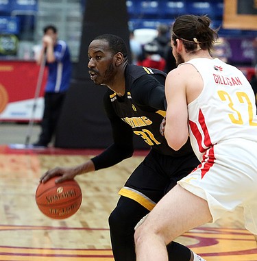 Kirk Williams Jr. of the London Lightning handles the ball while Devin Gilligan of the Sudbury Five defends during first-half National Basketball League of Canada action at Sudbury Community Arena in Sudbury on Sunday. (Ben Leeson/Postmedia Network)