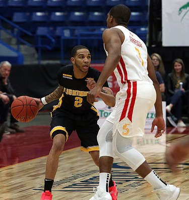 Xavier Moon of the London Lightning handles the ball while Georges Serresse of the Sudbury Five defends during first-half National Basketball League of Canada action at Sudbury Community Arena in Sudbury on Sunday.  (Ben Leeson/Postmedia Network)