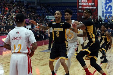 Xavier Moon of the London Lightning looks to interfere with an inbound attempt by Maurice Jones Sr. of the Sudbury Five while London's Mo Bolden and Sudbury's Cory Dixon jockey for position during first-half National Basketball League of Canada action at Sudbury Community Arena in Sudbury on Sunday.  (Ben Leeson/Postmedia Network)