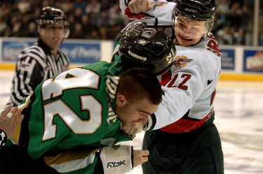 Mike Yovanic of the London Knights loses his helmet during a fight with Richard Greenop of the Windsor Spitfires at the drop of the puck last night at the John Labatt Centre. (2009)
