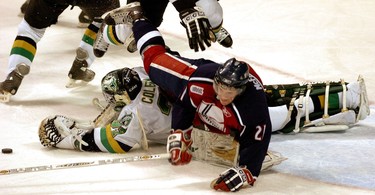 Windsor Spitfires forward Paul McFarland falls over Knights goaltender Gerald Coleman. (2005)