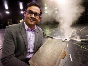 Jubayer Chowdhury a research scientist at the WindEEE institute at Western University holds a plastic mockup of a building that they use in their tornado simulator in London, Ont.  Chowdhury is heading a study into the Ottawa-Gatineau area tornado outbreak of 2018 that caused extensive damage. (Mike Hensen/The London Free Press)