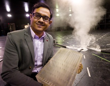 Jubayer Chowdhury, a research scientist at the WindEEE institute at Western University, holds a plastic mockup of a building that they use in their tornado simulator in London, Ont.  Chowdhury is heading a study into the Ottawa-Gatineau area tornado outbreak of 2018 that caused extensive damage. (Mike Hensen/The London Free Press)