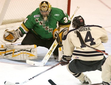 Windsor Spitfire Adam Henrique buries the puck behind London Knight goalie Jason Guy in the first period of an OHL game at Windsor Arena in 2008.