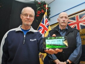 Tom Mountain, chair of the Royal Canadian Legion Branch 642 Memorial Field at Maple Leaf Cemetery in Chatham, left, holds a photo of the Veteran Memorial Chapel sign at the cemetery next to Len Maynard, the branch's first vice president, inside the branch on Tuesday, March 5, 2019. The metal lettering has gone missing from the sign. (Tom Morrison/Postmedia Network)